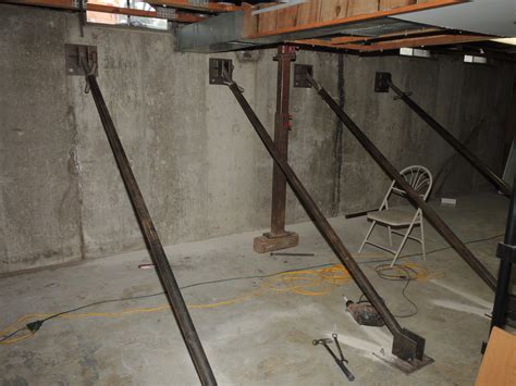 metal bracket concrete basement wall|secure basement wall to steel beam.